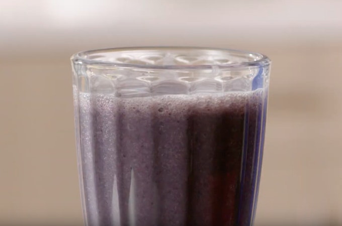Blueberry shake in tall glass with ridges